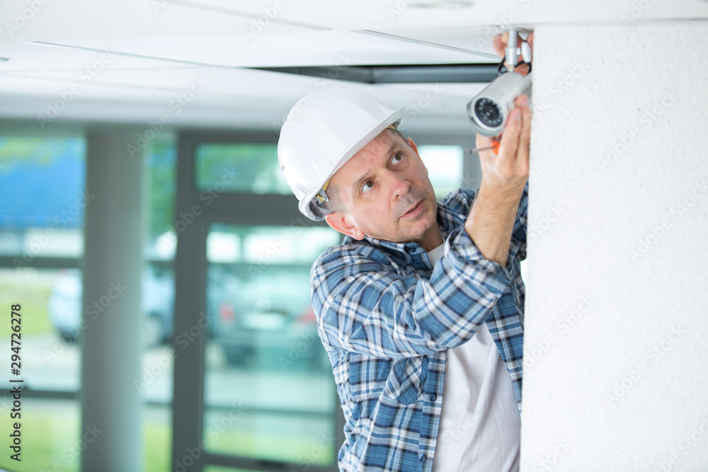 installer positioning the surveillance camera installer positioning the surveillance camera