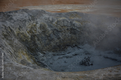Sculptures of boiling grey mud in Hverir, Krafla geothermal area, Iceland in summer, closeup.