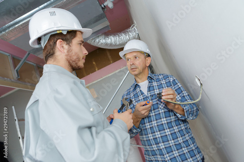 apprentice electrician learning about wiring a socket