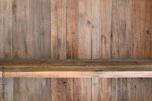 Empty wooden shelf on a wooden wall background texture. Copy space.