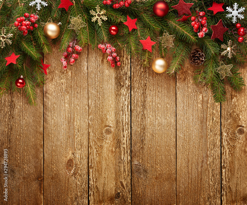 Christmas wooden background with decoration and fir tree. View with copy space.