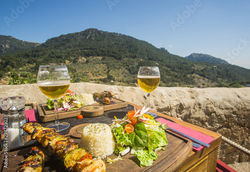 Beer and skewers on Lunch time in a restaurant that have a beautiful view of the valley and mountains at the village of Valldemossa in Palma de Mallorca Spain. 