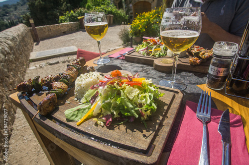 Beer and skewers on Lunch time in a restaurant that have a beautiful view of the valley and mountains at the village of Valldemossa in Palma de Mallorca Spain. 