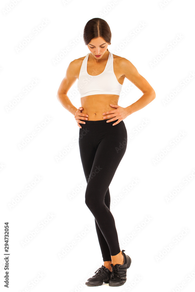 Sexy fitness woman posing in studio - isolated on a white background Sexy fitness woman posing in studio - isolated on a white background
