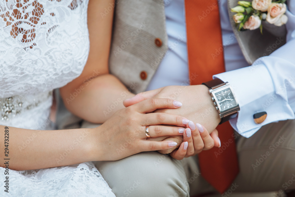  bride and groom hold hands. hand plan