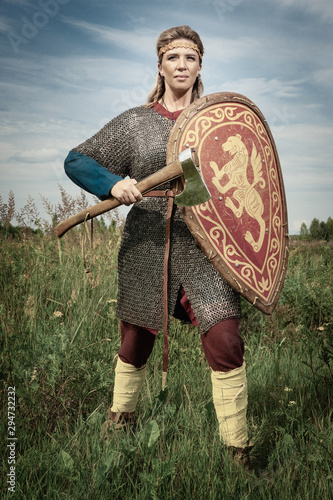 Viking girl warrior with axe in hand fighted.. photo