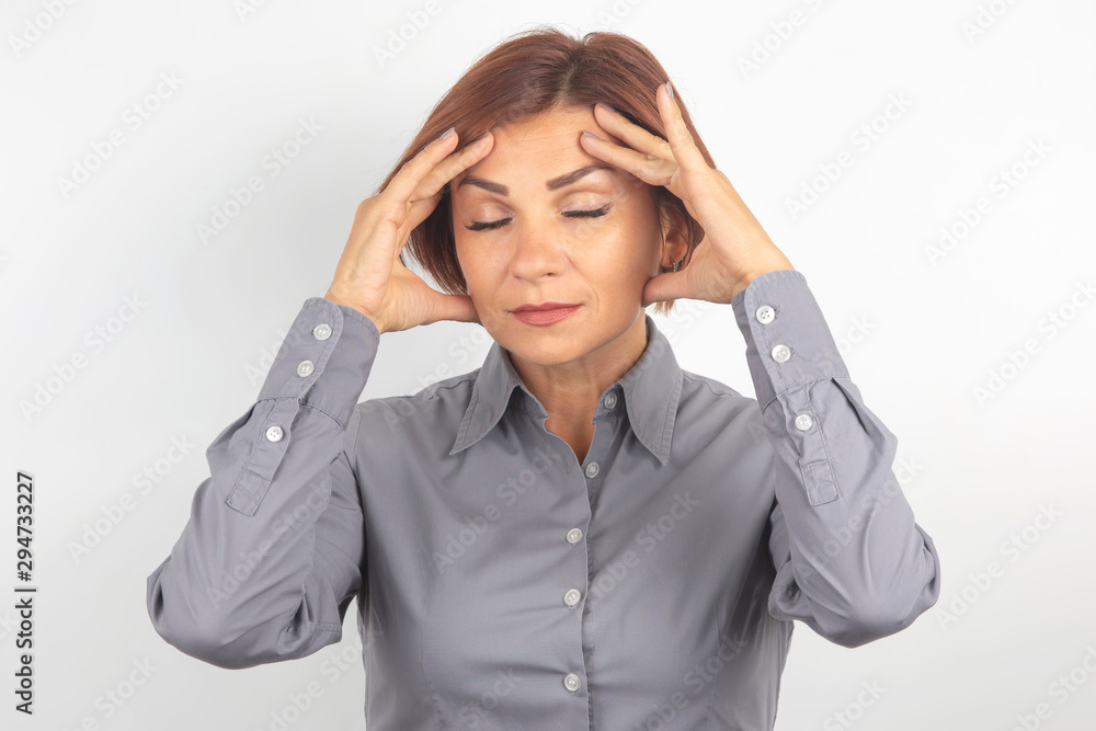 Beautiful young business girl with closed eyes thinks over her project on a white background. thoughts and stress. Beautiful young business girl with closed eyes thinks over her project on a white background. thoughts and stress.