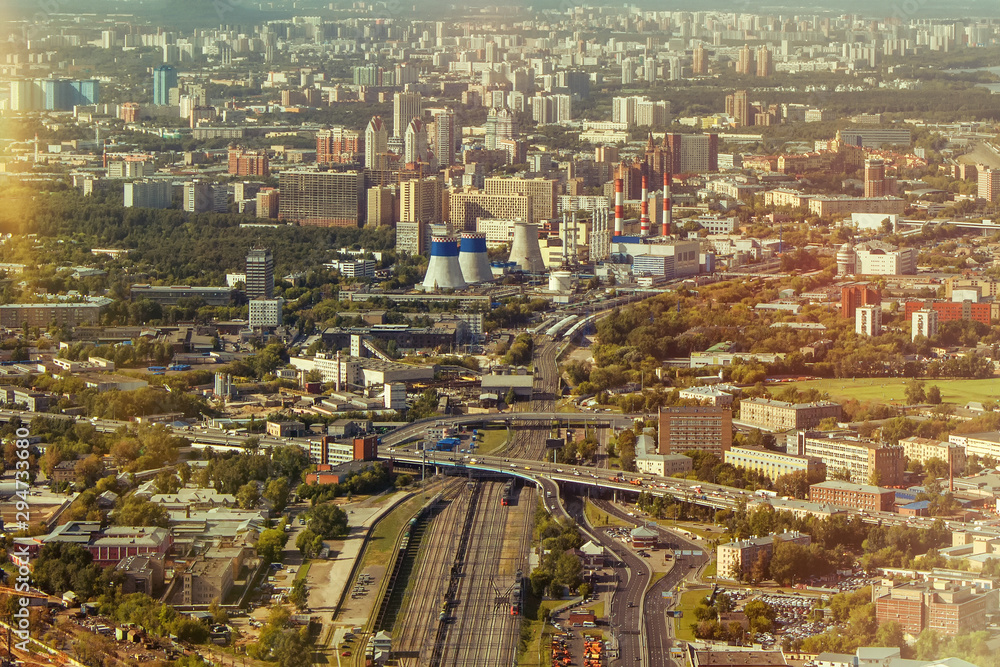 View of the city from the top. Moscow from the observation deck. Houses, streets and roads of the city. The railway divides the city in half