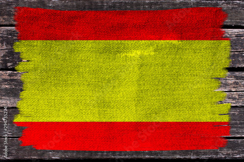 photo of the beautiful colored national flag of the modern state of Spain on a textured fabric, concept of tourism, economics and politics, closeup