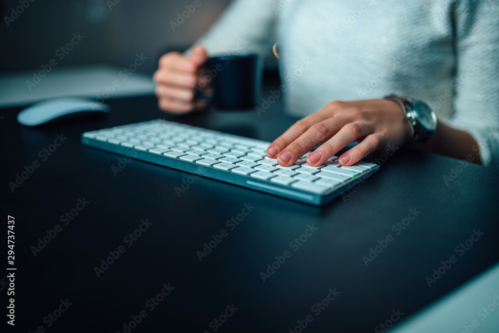Cropped view of woman using computer keyboard at night, copy space. Cropped view of woman using computer keyboard at night, copy space.