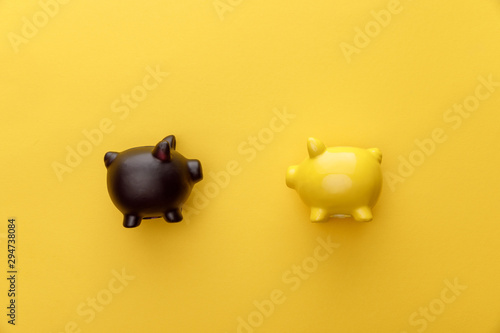 top view of piggy banks on yellow background