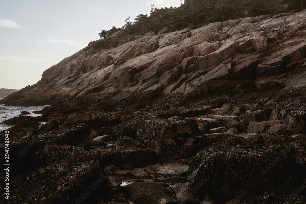 Sunset over rugged coastline of Sand Beach on a cool Fall evening in Acadia National Park on Mount Desert Island, Maine. Sunset over rugged coastline of Sand Beach on a cool Fall evening in Acadia National Park on Mount Desert Island, Maine.