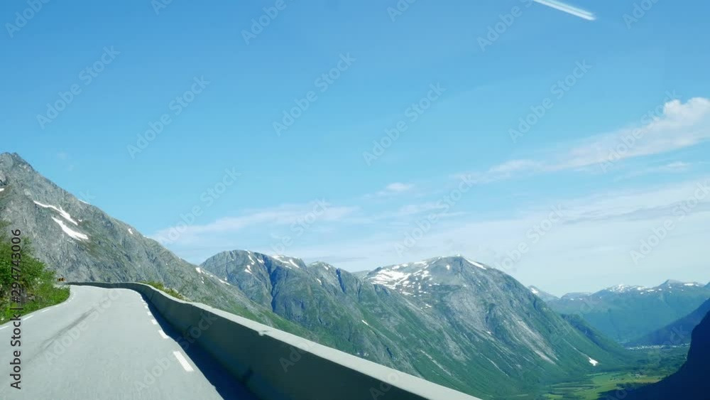 Driving in a car up switchbacks on a steep mountain road in Norway with