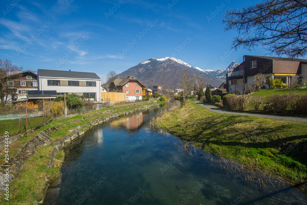 Beautiful river and mountains view from a little village with the name Niederurnen in Switzerland. 