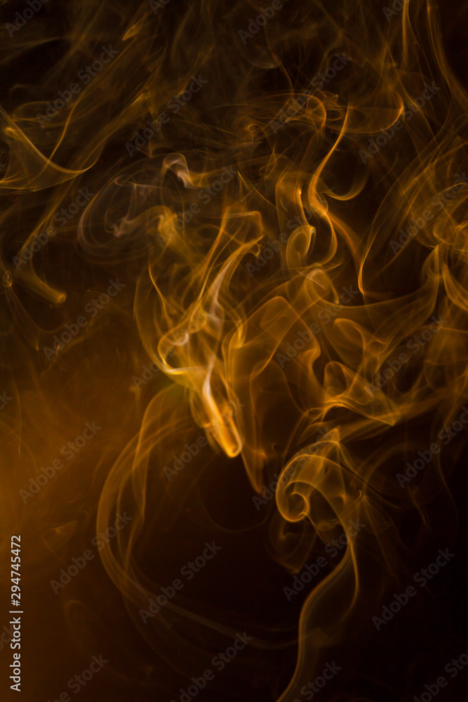 Obraz premium Gold smoke on black background.