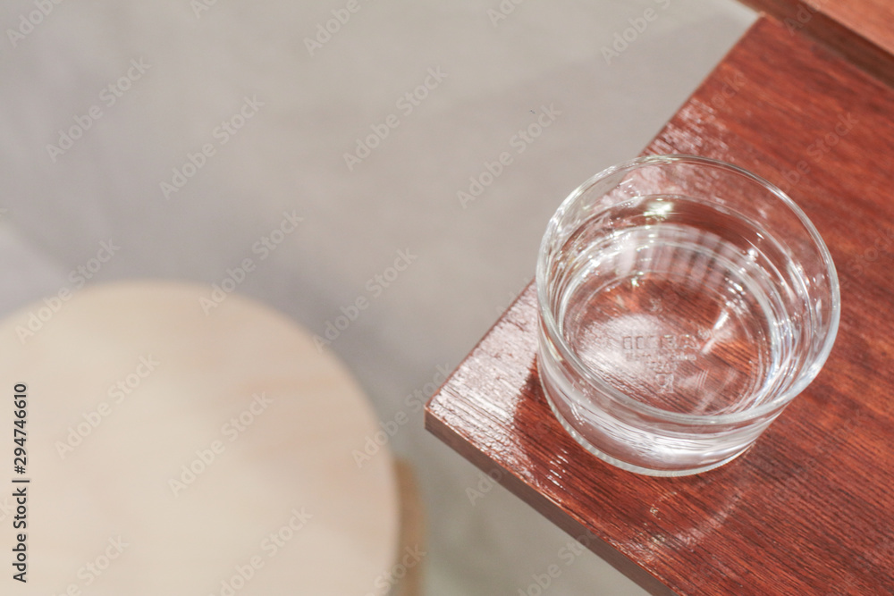 The bottle and clean glass of water on wooden background.selective focus, blur some part. The bottle and clean glass of water on wooden background.selective focus, blur some part.