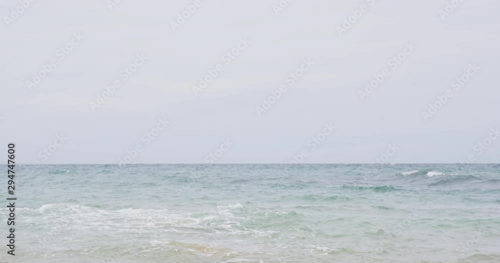 Triathlon swimming man. Male triathlete swimmer running into ocean for swim. Fit man starting swimming with sprinting start. Man in professional triathlon suit training for ironman on Hawaii.