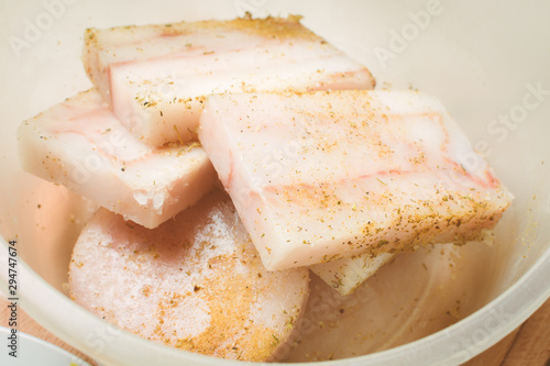 Raw fillet of mintai fish marinated in deep egg pan for cooking.