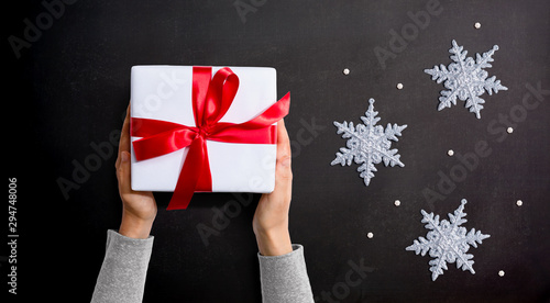 Person holding a Christmast gift box - overhead view flat lay photo