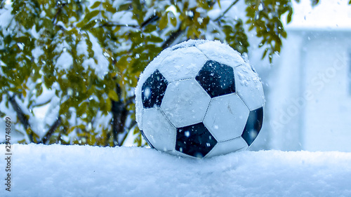 Football, Soccer ball on snow during snow fall © oasisamuel