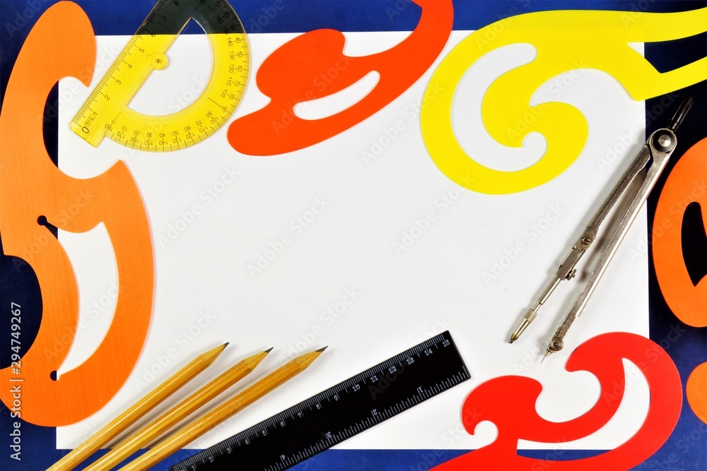 Fototapeta premium A tool for drawing lessons and creativity in school. Background for Drawings-graphic image made in scale, pattern-template for building curves, compasses for drawing circles, ruler, pencil.
