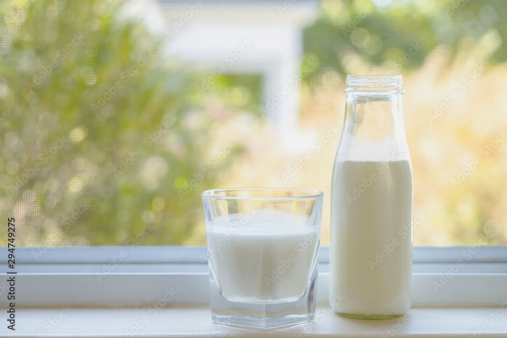 Reptientes with milk on the window view background. Alternative milk concept. Front view. Horizontal composition Reptientes with milk on the window view background. Alternative milk concept. Front view. Horizontal composition