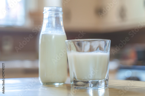 Reptientes with milk on a wooden table and rustic kitchen background. Alternative milk concept. Front view. Horizontal composition