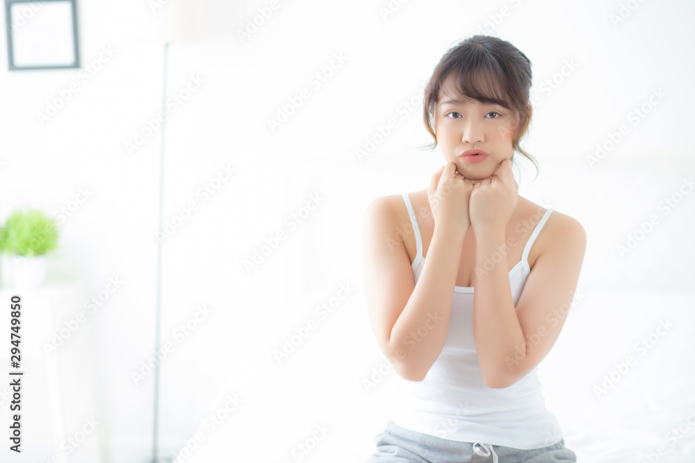 Portrait of beautiful young asian woman smile while wake up healthy and wellness with sunrise at morning in the bedroom, asia girl skin care with happy with fresh, lifestyle and relax concept. Portrait of beautiful young asian woman smile while wake up healthy and wellness with sunrise at morning in the bedroom, asia girl skin care with happy with fresh, lifestyle and relax concept.
