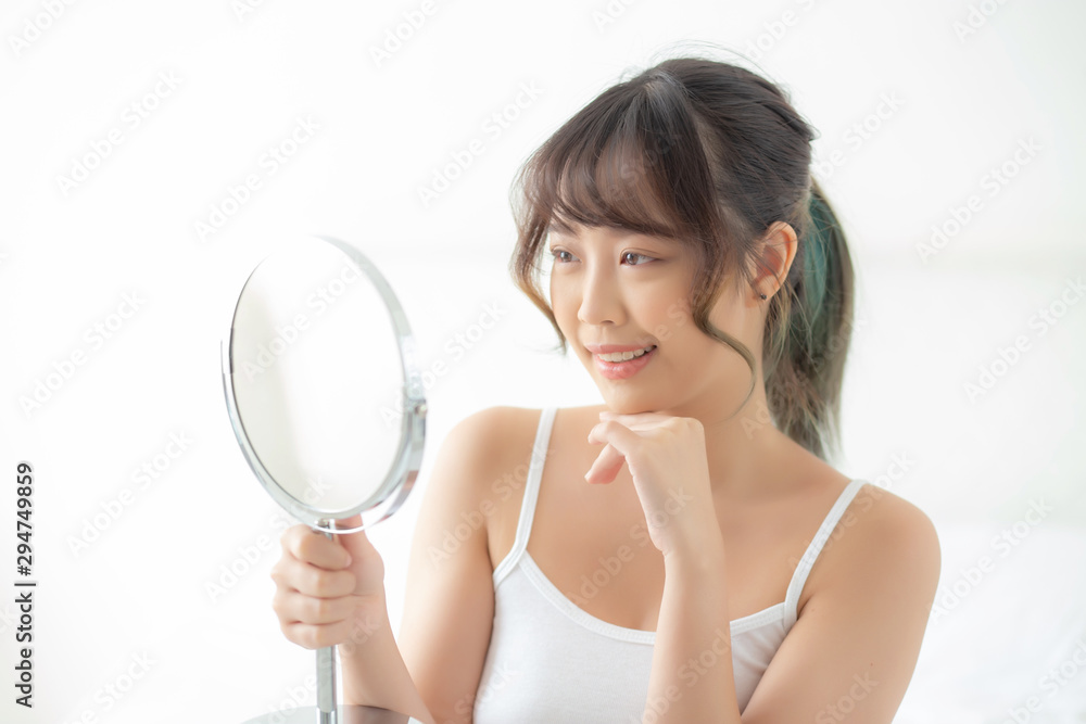 Beautiful face young asian woman with happy smiling and looking mirror, makeup of beauty facial girl with skincare and cosmetic treatment, refresh of female and clean for charming, healthy concept. Beautiful face young asian woman with happy smiling and looking mirror, makeup of beauty facial girl with skincare and cosmetic treatment, refresh of female and clean for charming, healthy concept.