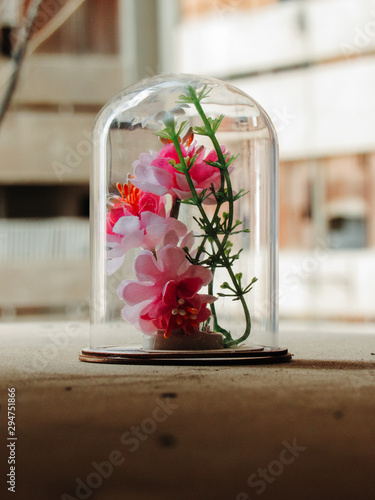 bouquet of roses in glass vase on wooden table