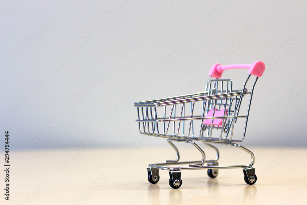 Empty shopping cart on wooden Empty shopping cart on wooden