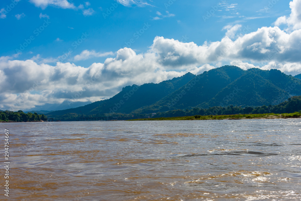 Beautiful green hills landscape and rivers on blue sky background. decoration image contain certain grain noise and soft focus.