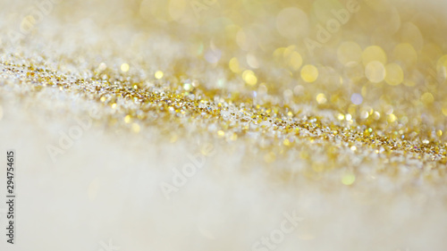 Lights on gold with star bokeh background.Gold celebration background for anniversary, New Year Eve, Christmas, falling coins, wedding or birthday