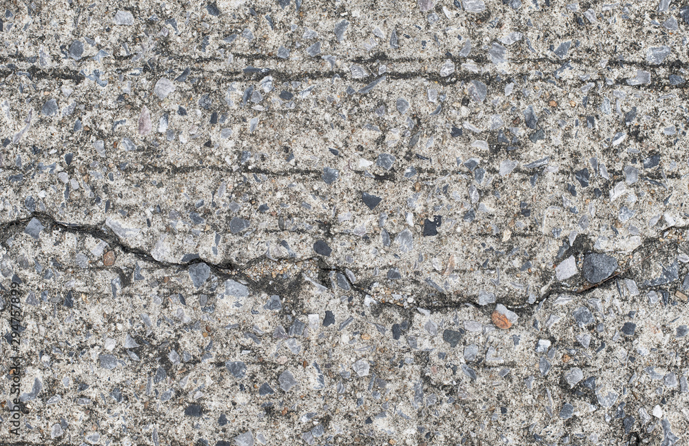 The texture of the background image, stone floor, concrete, patterns with cracks and jagged gray black The texture of the background image, stone floor, concrete, patterns with cracks and jagged gray black
