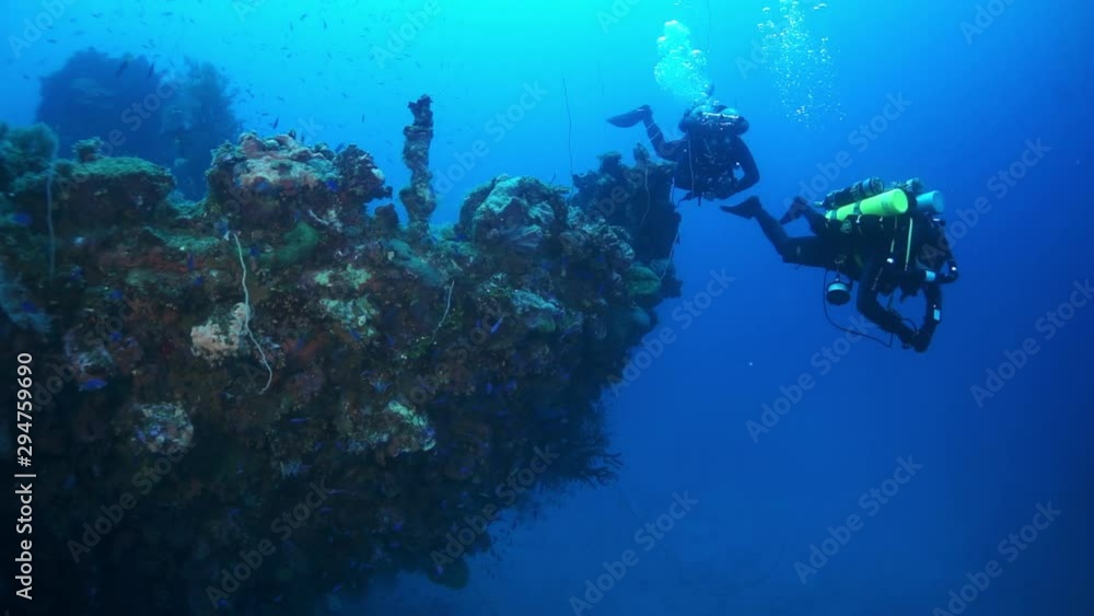 Diving on shipwreck underwater on seabed of Pacific Ocean on Chuuk Islands. Sunken ship in sea life of Truk. Diving on shipwreck underwater on seabed of Pacific Ocean on Chuuk Islands. Sunken ship in sea life of Truk.