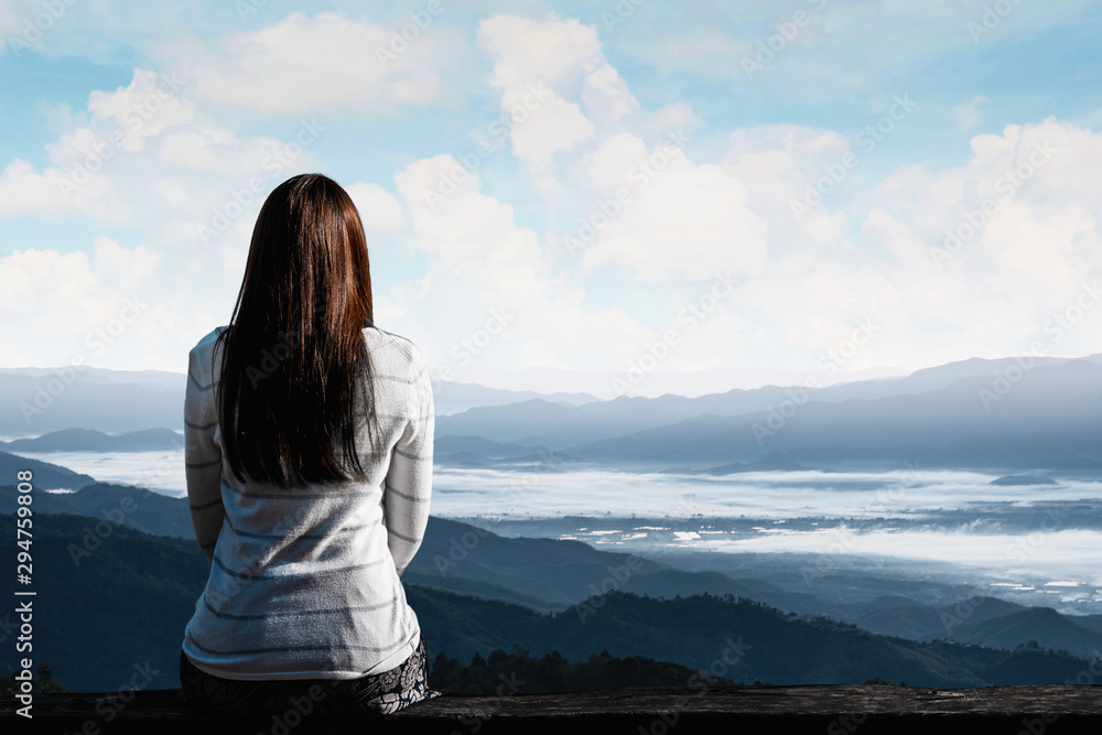 Traveler woman is sitting looking at the view of mountains natural background.
