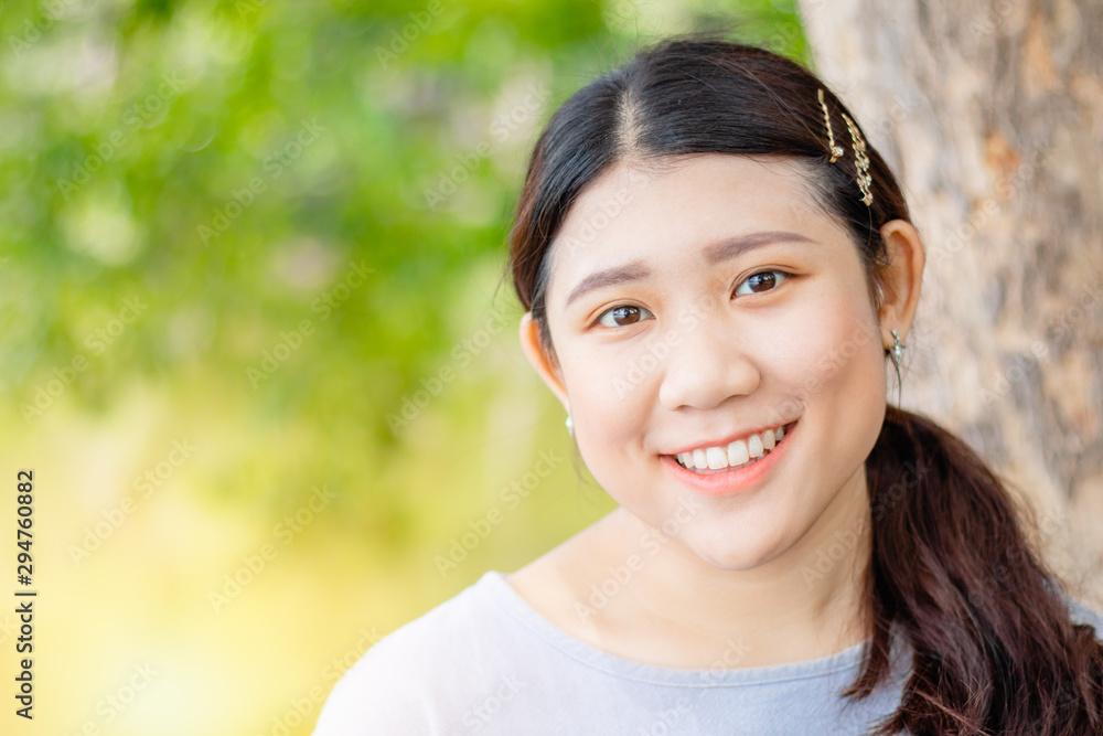 Innocent beautiful cute girl teeth smiling portly shape healthy Asian race outdoor green nature. Innocent beautiful cute girl teeth smiling portly shape healthy Asian race outdoor green nature.