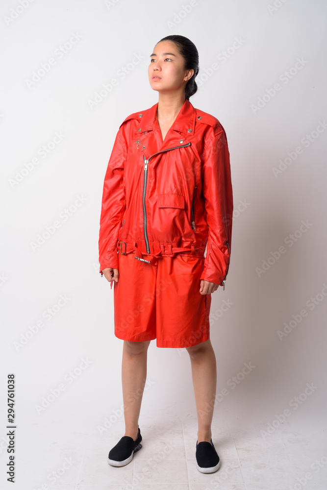 Full body shot of young Asian rebellious woman thinking Full body shot of young Asian rebellious woman thinking
