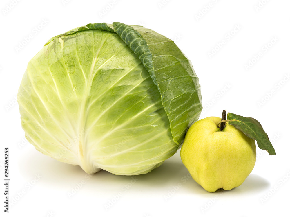 Naklejka premium green cabbage next to quince on a white background