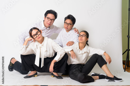 Group shot of Asian business people sitting on the floor together