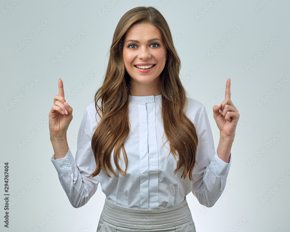 smiling woman in white shirt pointing finger to copy space. smiling woman in white shirt pointing finger to copy space.