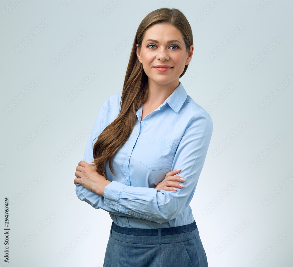 young smiling business woman in blue shirt standing with crossed arms. young smiling business woman in blue shirt standing with crossed arms.
