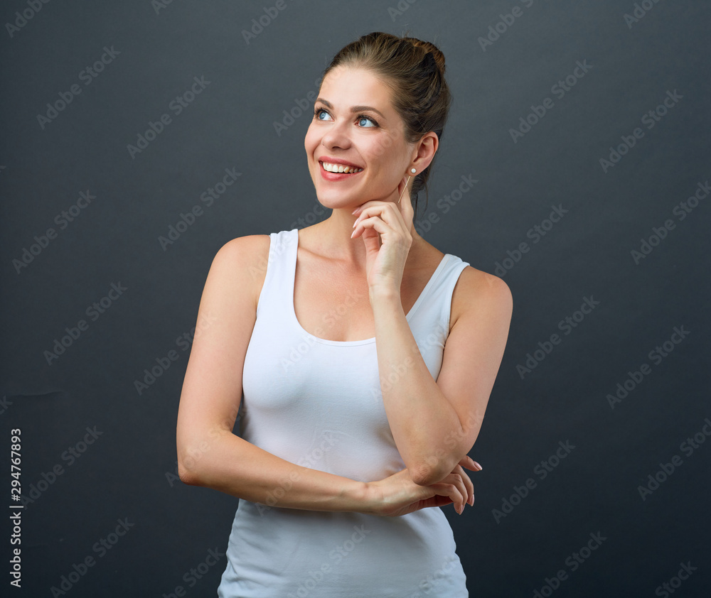 smiling woman in sporty style wearing white vest looking away to side. smiling woman in sporty style wearing white vest looking away to side.