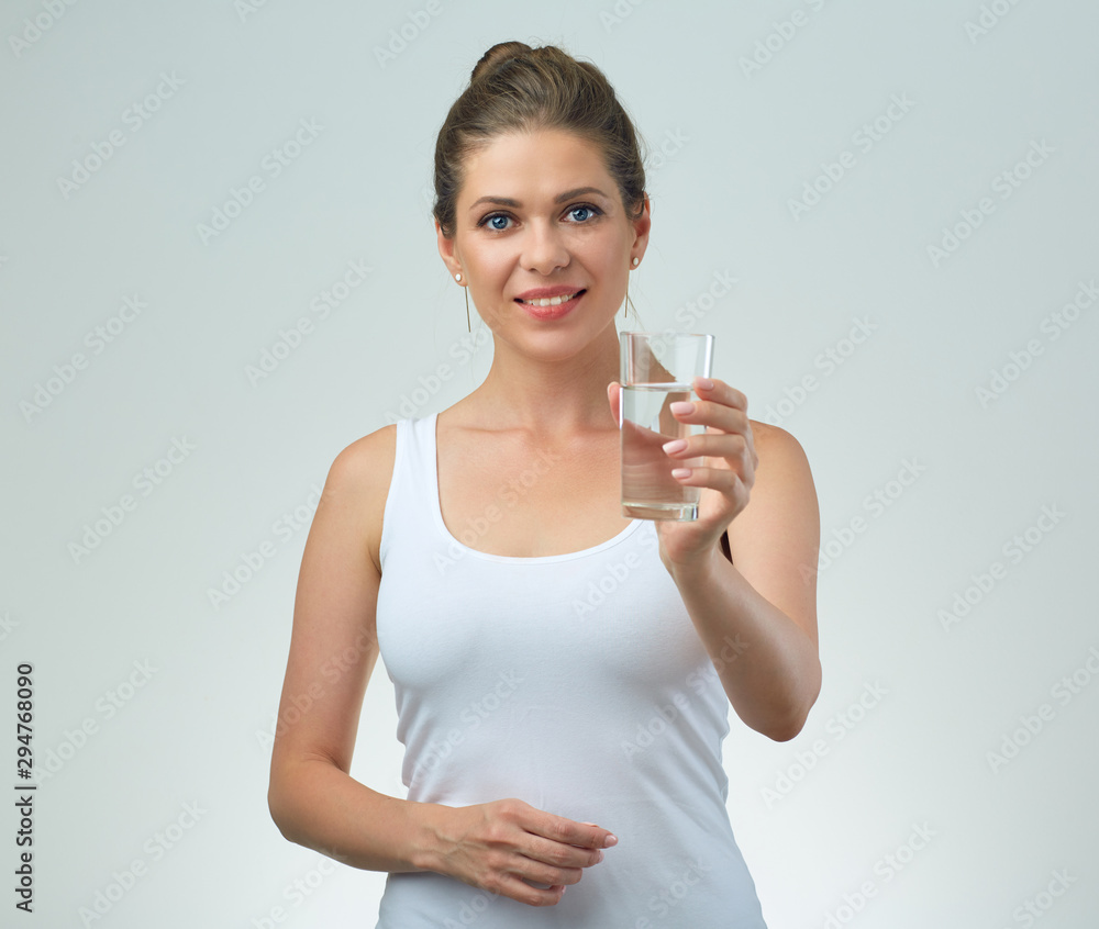 smiling woman in white casual vest holding water glass in front of. smiling woman in white casual vest holding water glass in front of.