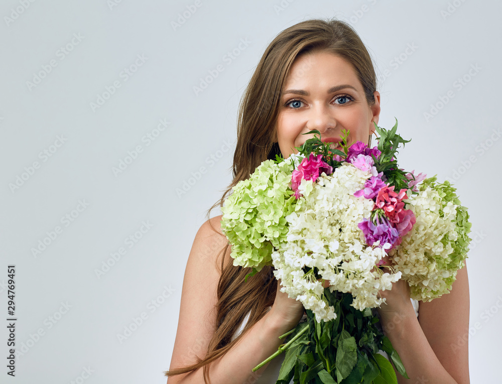 Beautiful smiling girl holding flowers.