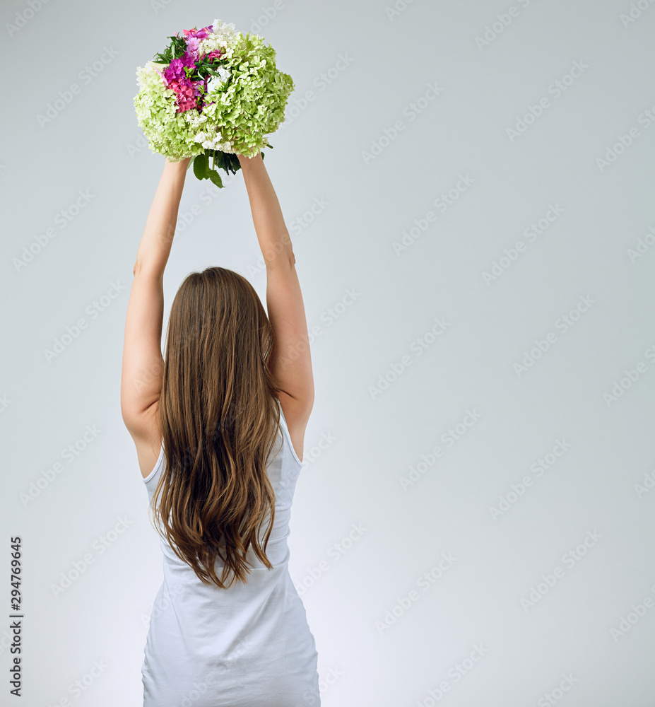 Woman standig back with flowers bouquet overhead holding. Woman standig back with flowers bouquet overhead holding.