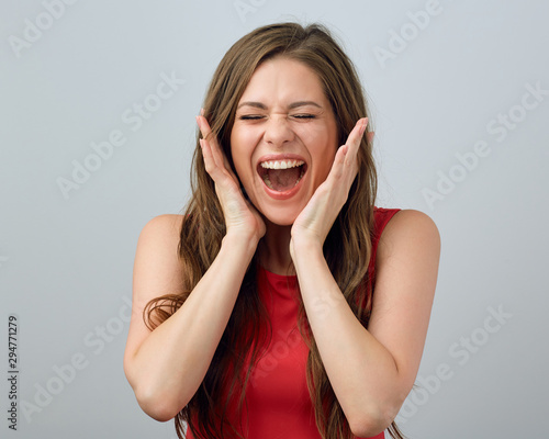 Happy screaming woman touching face.