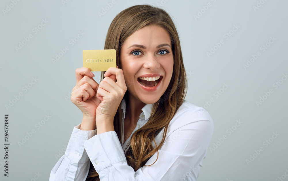 Happy woman in white shirt holding credit card. Happy woman in white shirt holding credit card.