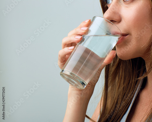 Woman drinking water from glass.