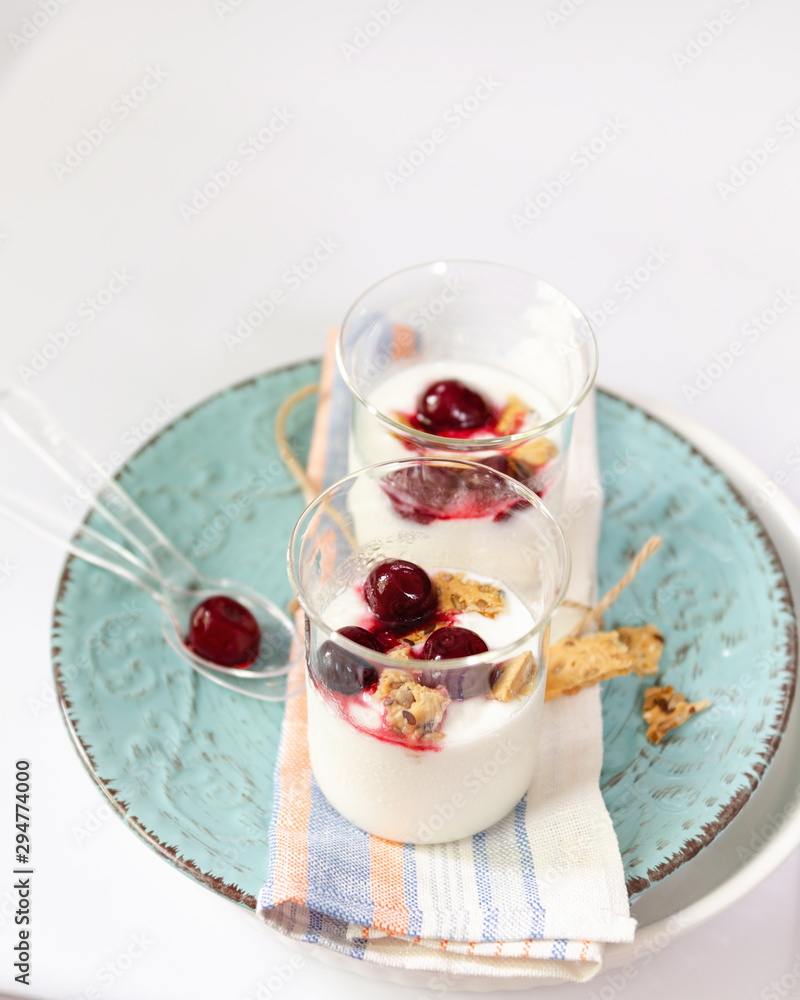 Natural yogurt, cookies and cherries served. Healthy dessert. Portion desert in glass. Copy space. Natural yogurt, cookies and cherries served. Healthy dessert. Portion desert in glass. Copy space.
